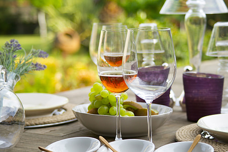 two wine glasses near bowl of white grapes wallpaper thumbnail
