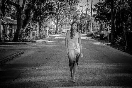 Greyscale Photo of Woman Standing on Street thumbnail