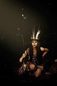 woman kneeling on ground while holding stick thumbnail