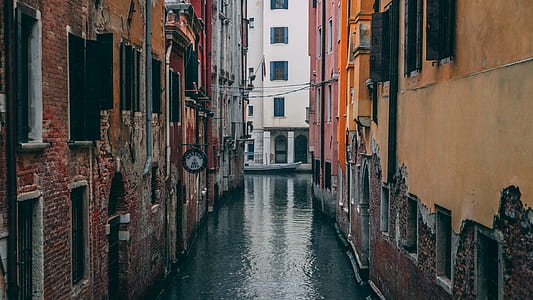 canal between concrete buildings at daytime thumbnail