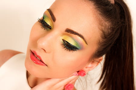 photo of woman wearing white top with green eyeshadow and red lips thumbnail