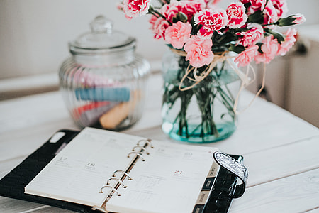 Organizer, mobile phone and lovely pink flowers thumbnail