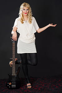 woman holding black bass electric guitar thumbnail