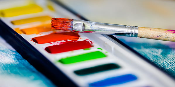 brown wooden brush on top of watercolour pallete thumbnail