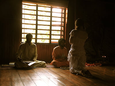 girl kneeling on floor facing men thumbnail