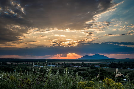 landscape photography of mountain under gray sky thumbnail
