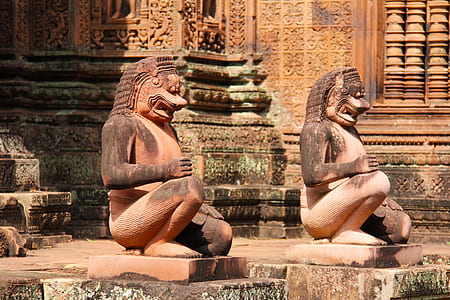 two brown statuettes thumbnail