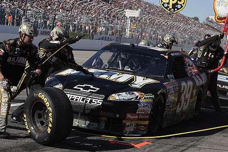 black Chevrolet Impala SS NASCAR stock car at pit stop thumbnail
