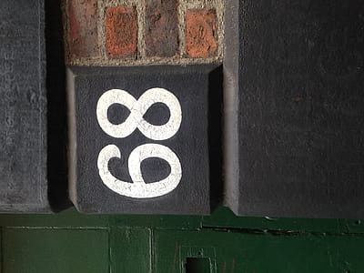 Original number 68 sign on a Victorian building in Manchester's Northern Quarter. thumbnail