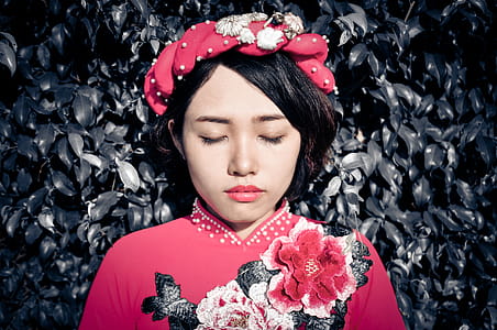 Woman With Her Eyes Closed Wearing Pink Floral Top thumbnail