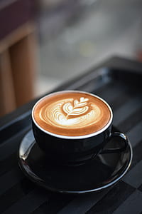 black ceramic teacup filled with coffee thumbnail