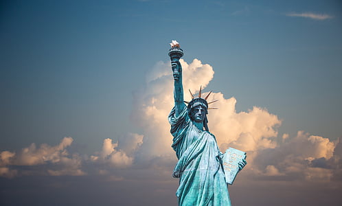 statue of Liberty under cloudy blue sky during daytime thumbnail