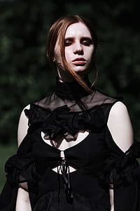 selective focus photography of woman wearing black cold-shoulder top thumbnail
