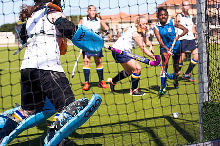 group of people playing field hockey thumbnail