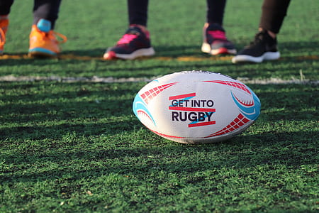 white and blue Rugby ball placed on ground thumbnail