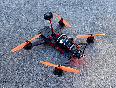 orange and black radio-controlled drone on gray concrete thumbnail