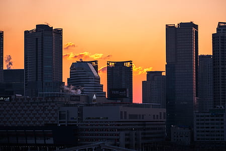 sunset over city buildings thumbnail