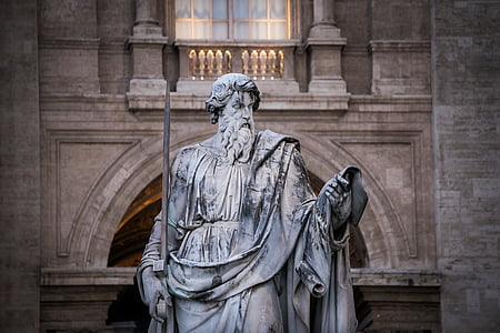 closeup photo of man holding bar statue thumbnail