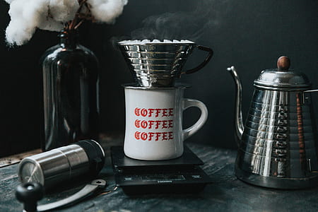 stainless steel cup on top of white mug thumbnail