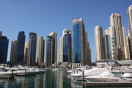 white boats on body of water near building thumbnail