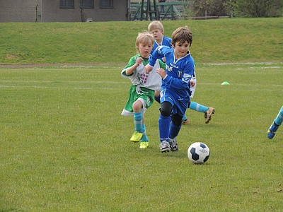 boy playing soccer in field thumbnail