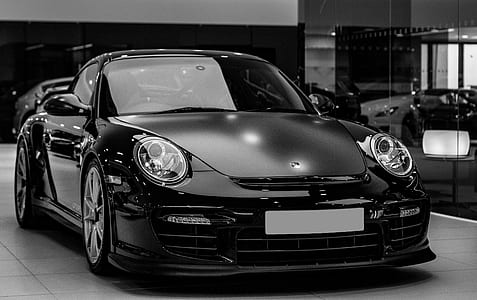 grayscale photography of Porsche 911 coupe inside room thumbnail