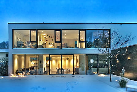 glass house across snow covered ground thumbnail