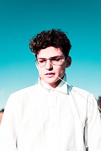 man wearing white shirt with stick in mouth thumbnail