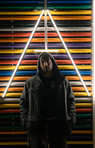 colorful metal fence behind standing man thumbnail