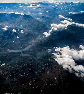 aerial view of green fields and mountains thumbnail