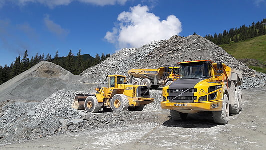 three heavy equipment vehicles on quarry thumbnail