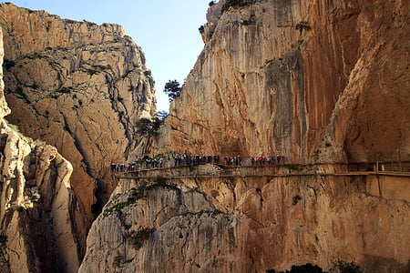brown mountain with people on cliff thumbnail