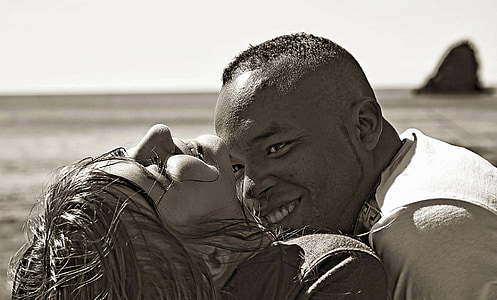 smiling man looking on woman in grayscale photography thumbnail