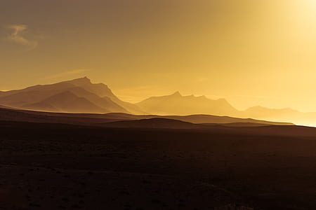 silhouette of mountains during golden hour thumbnail