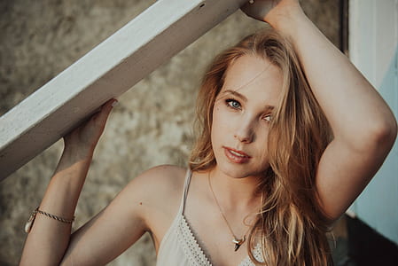 shallow focus photography of woman holding plank thumbnail