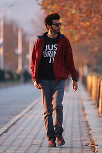man walking on gray concrete road thumbnail