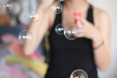 woman wearing black tank top with blowing bubbles thumbnail