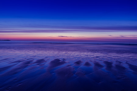Beach at low-tide during a sunset at Watergate Bay in Cornwall, England thumbnail