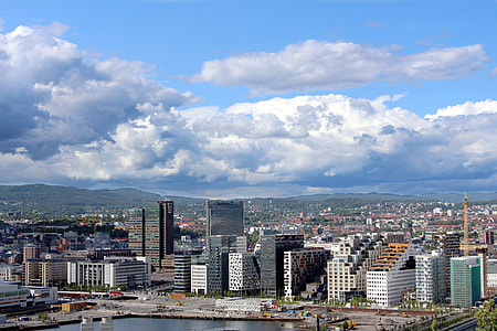 white clouds over city buildings during daytime thumbnail