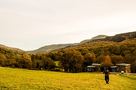 Person Standing at Green Field thumbnail