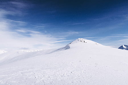 snow covered mountain under blue sky thumbnail