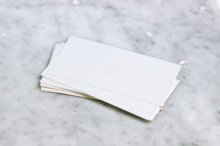stacked paper on marble surface thumbnail