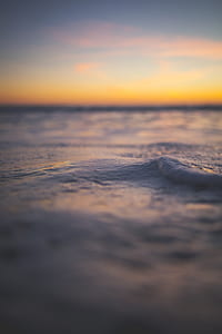 shallow focus photography of sea foams during sunset thumbnail