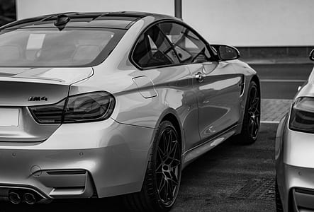 grayscale photography of coupe parked beside another car thumbnail