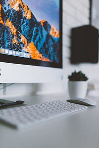 silver iMac, Apple Magic Keyboard, and Apple Magic Mouse on desk thumbnail