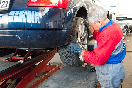 person looking at vehicle wheel inside shop thumbnail