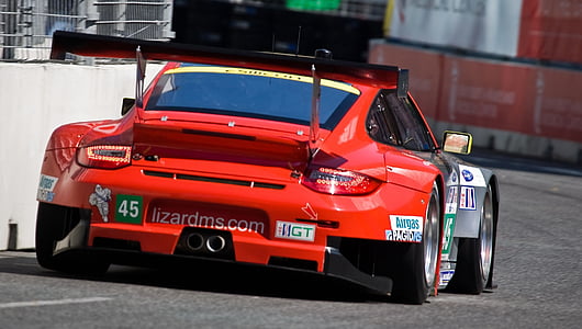 red sports coupe on tarmack thumbnail