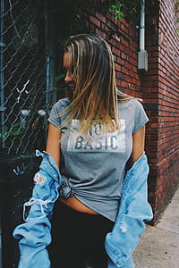 woman in gray shirt and black pants looking sideways thumbnail