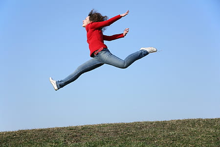 woman jumping on green grassfield thumbnail