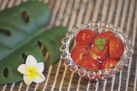 Tomatoes on glass bowl in shallow focus lens thumbnail